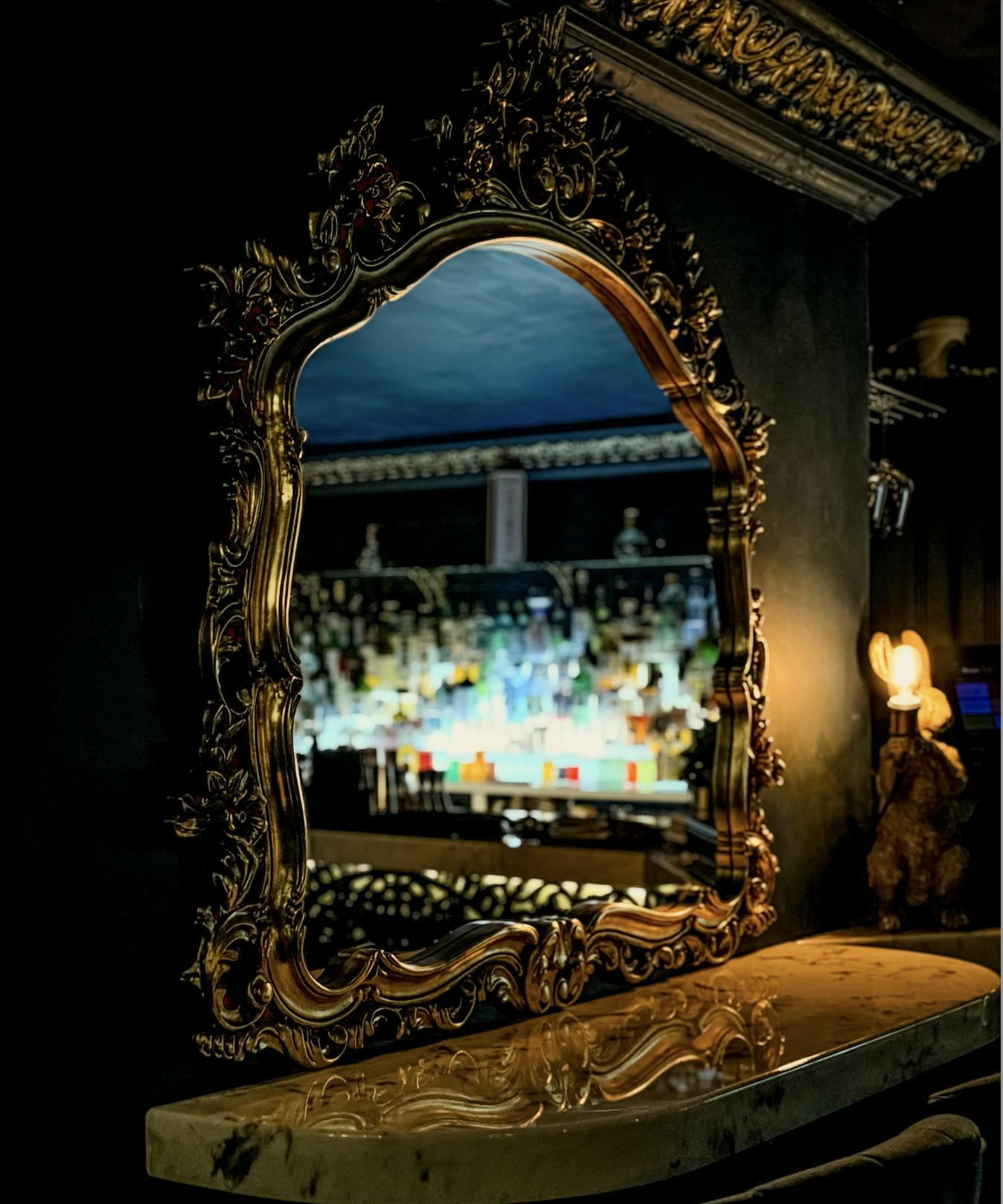 Elegant bar with ornate mirror, ideal for upscale events and cocktail receptions.