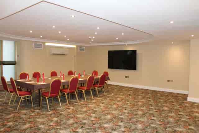 Oxford Suite meeting room with red chairs, ideal for professional events and workshops.