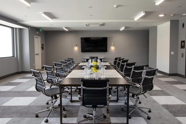 Modern meeting room at Olia Restaurant, featuring ergonomic chairs for corporate events.
