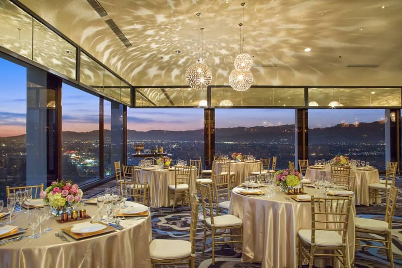 Elegant wedding venue at Sheraton Universal with city skyline view and floral decor.