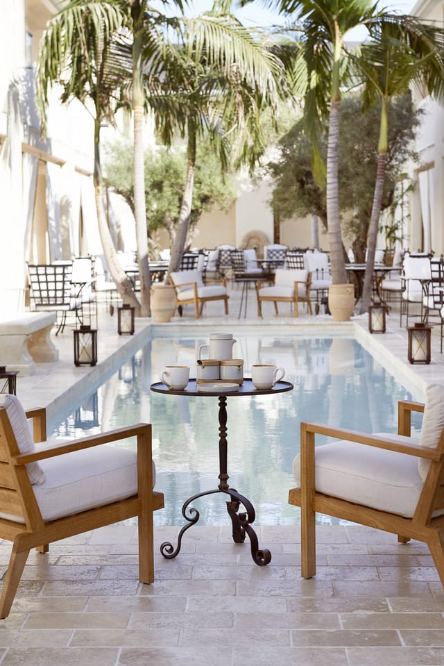 Balcony Rooms at Cara Hotel: elegant outdoor meeting space with pool seating for events.