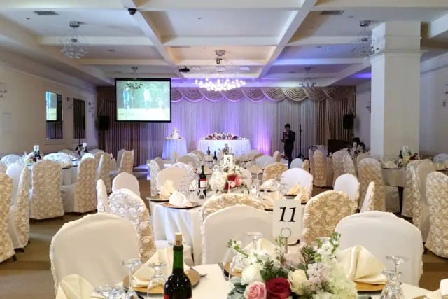 Elegant banquet hall with floral centerpieces for weddings and formal events.