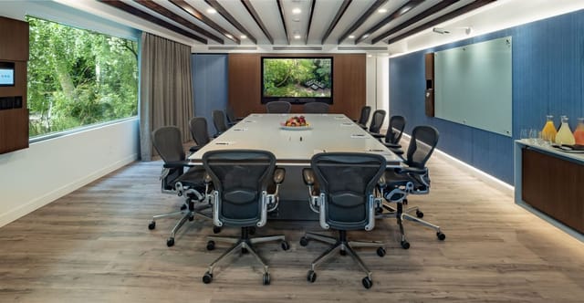 Modern West Hollywood boardroom with large table, ideal for meetings and presentations.