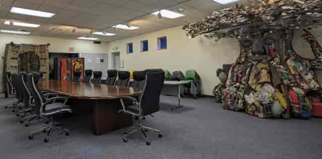 Large conference room with ergonomic chairs and tree art, perfect for meetings and events.