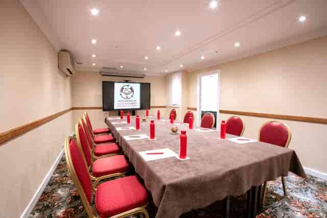 Brompton Boardroom with long table, red candles for formal meetings in London.