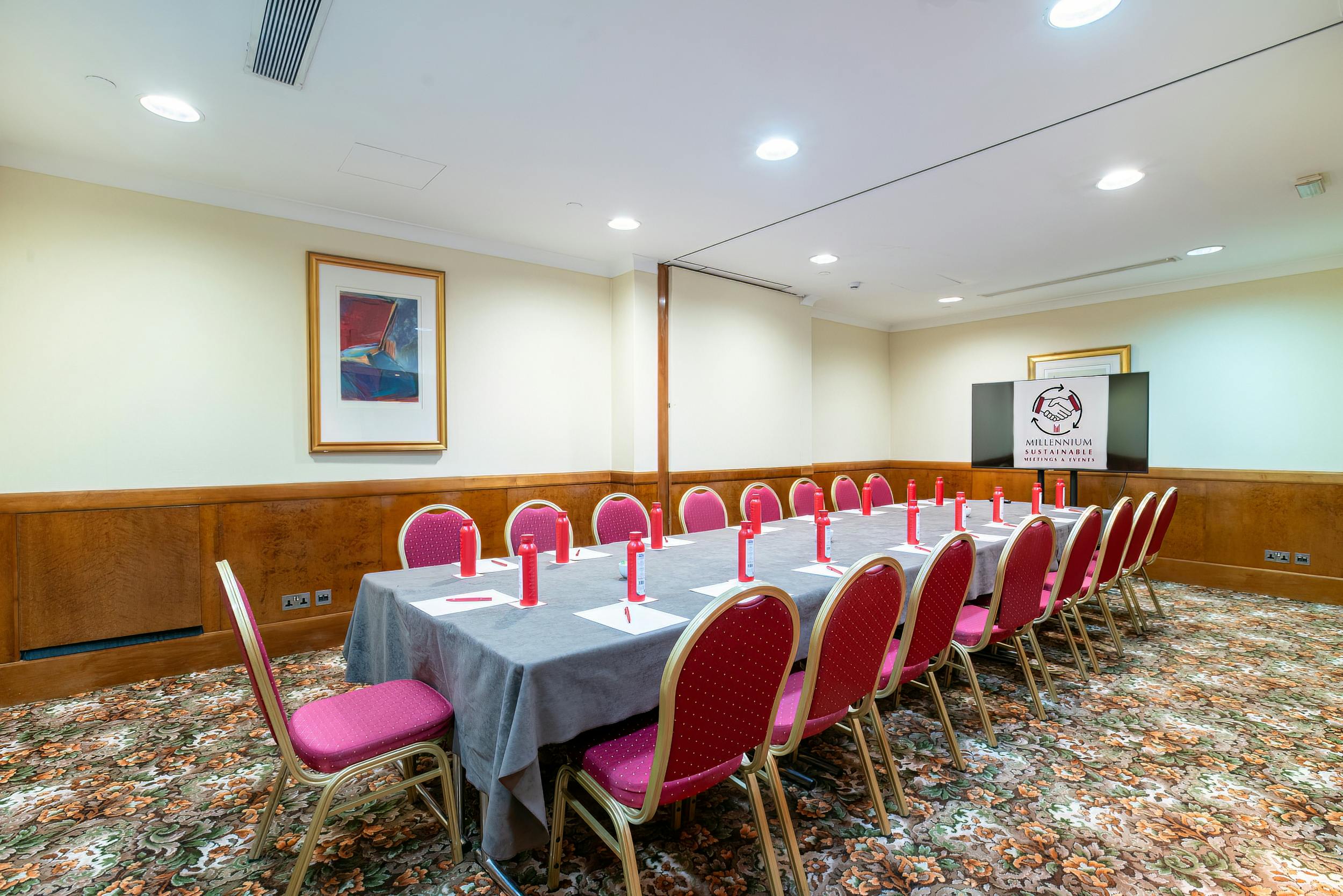 Duke Boardroom in London with long table, pink chairs for meetings and workshops.