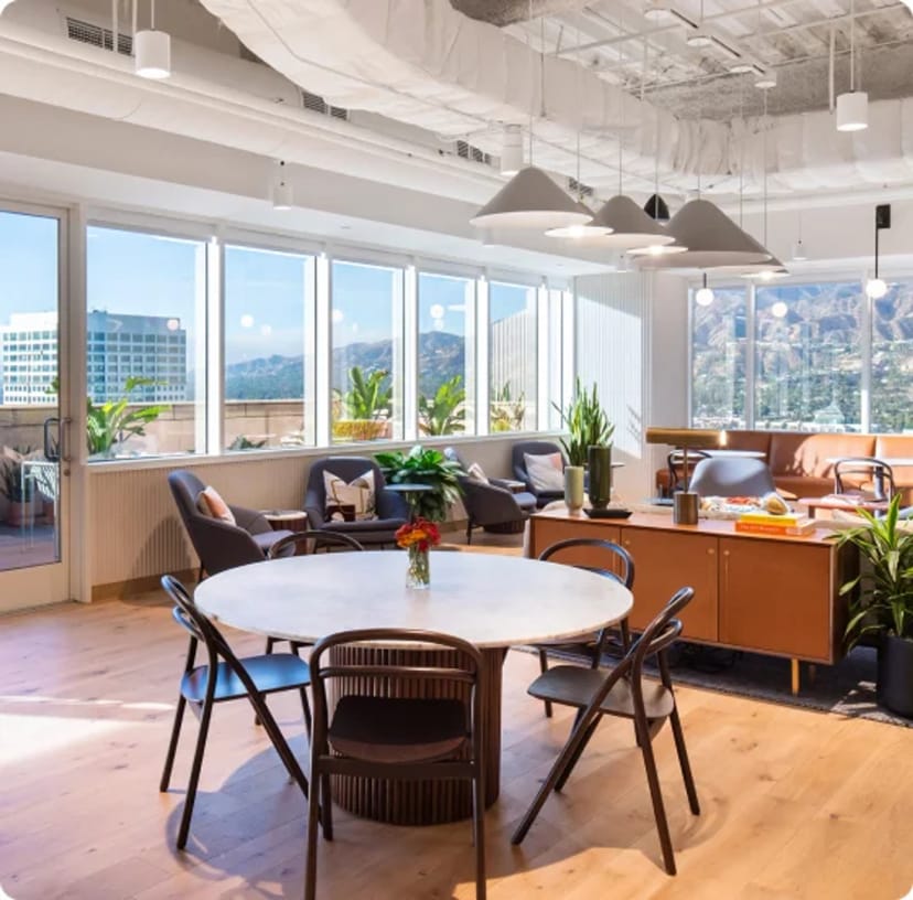 Bright modern meeting space with large windows for collaborative sessions and events.