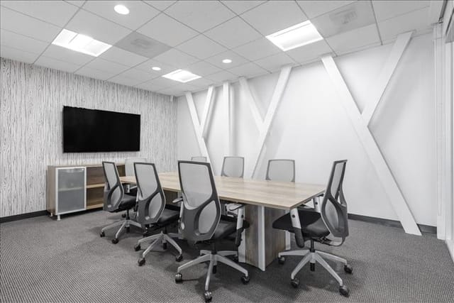 Modern meeting room with large table and ergonomic chairs at Brand Boulevard Executive Center.