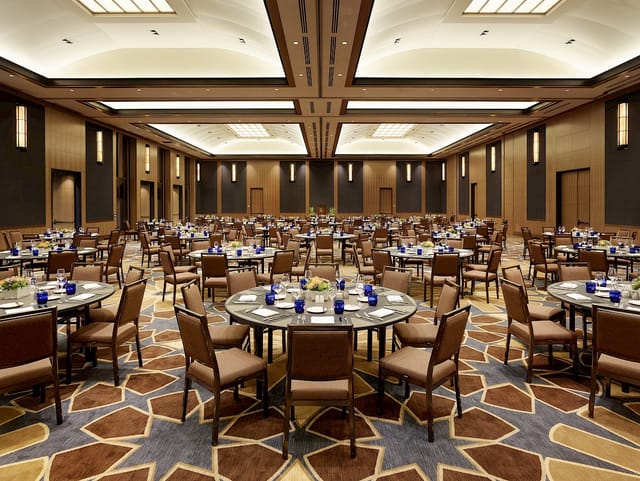Tiered classroom at UCLA Luskin Center, set for elegant corporate event with blue decor.