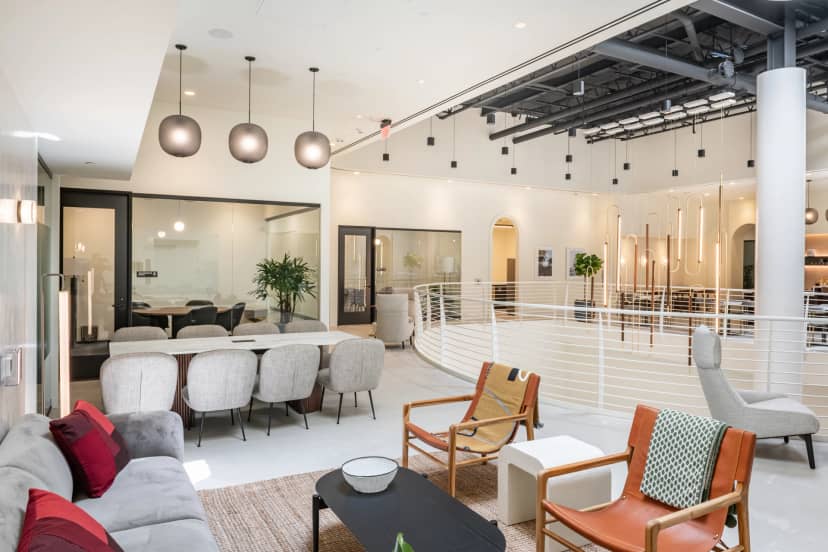 Modern open-concept executive suite for collaborative meetings and events.