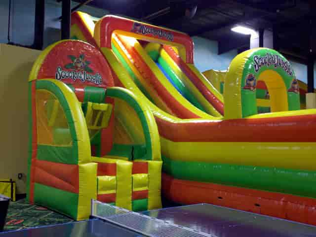 Vibrant inflatable slide at Scooter's Jungle for toddler parties and family events.