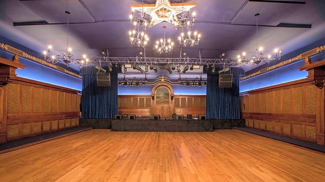 Elegant performance stage with chandeliers in Grand Lodge of Los Angeles for upscale events.