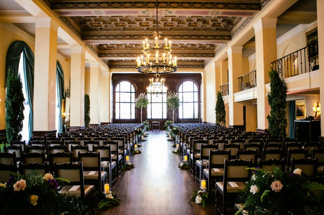 Elegant Lounge & Art Salon wedding venue with chandeliers and floral decor.