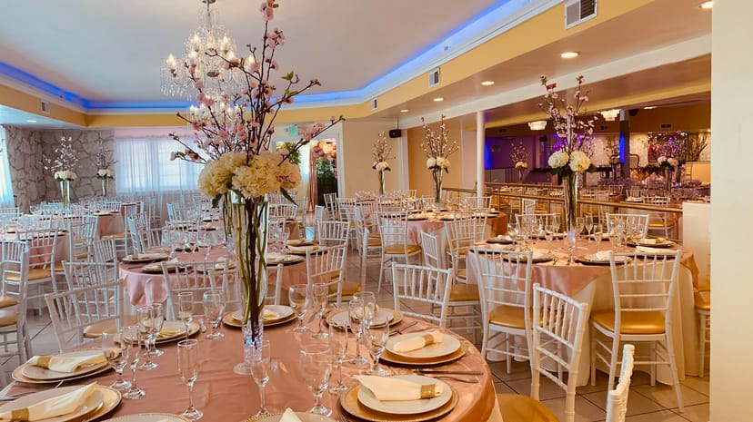 Elegant banquet hall with floral centerpieces, ideal for weddings and formal events.