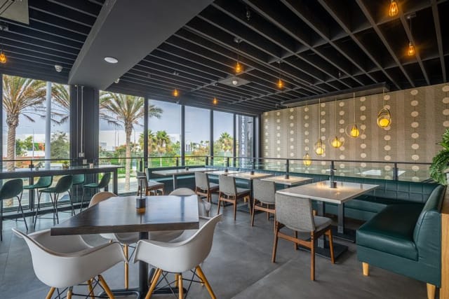 Modern event space in Cork & Batter with natural light and stylish seating for networking.