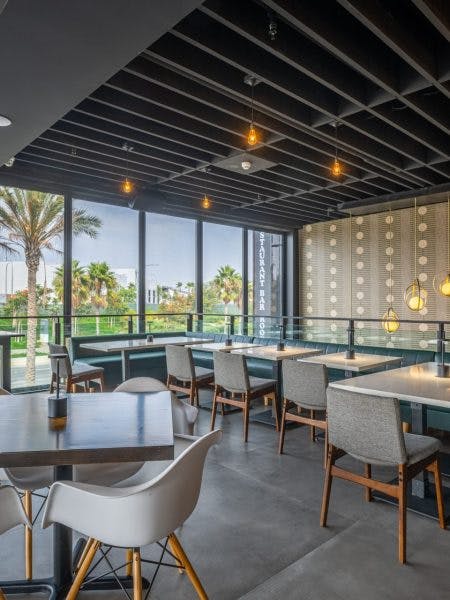 Modern private dining room with large windows, perfect for events in Cork & Batter.