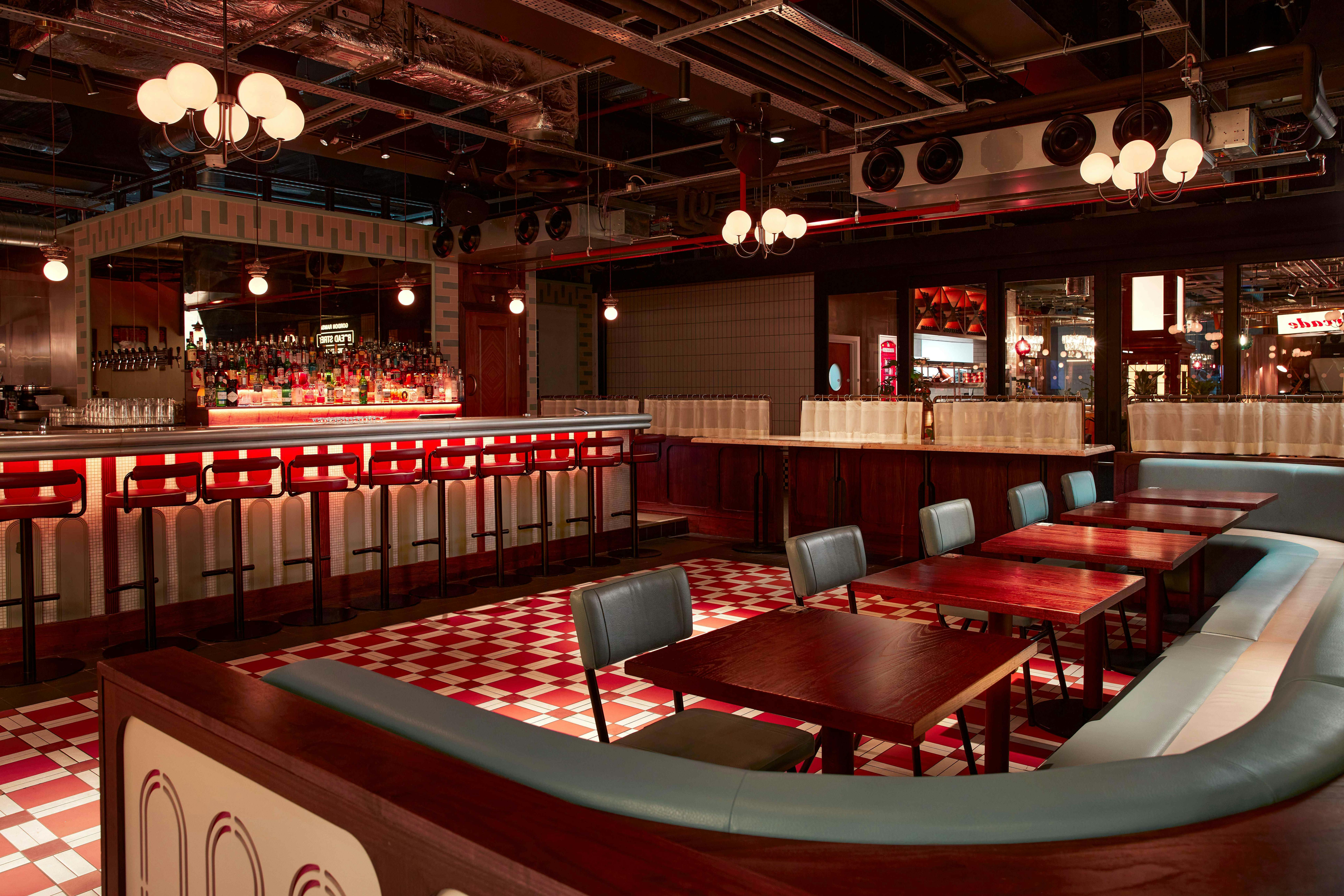Arcade Food Hall in Battersea, stylish venue with checkered floor for events and gatherings.