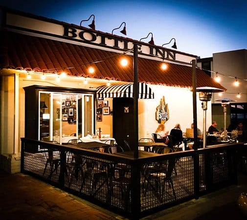 Outdoor patio at The Bottle Inn Hermosa, cozy dining space for events and gatherings.