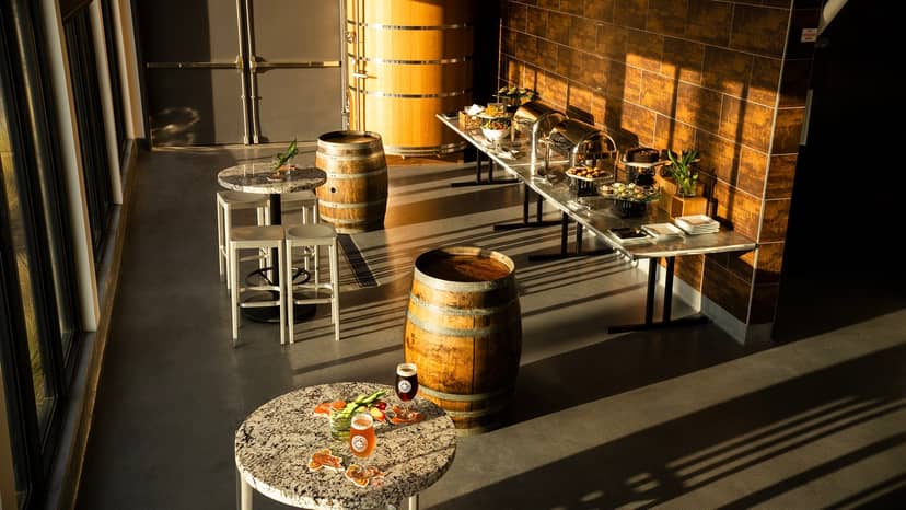 Stylish event space at Ballast Point Brewing with rustic wooden barrels, ideal for gatherings.