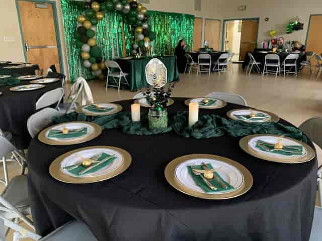 Elegant event space at Alta Vista Community Center with black and gold decor.