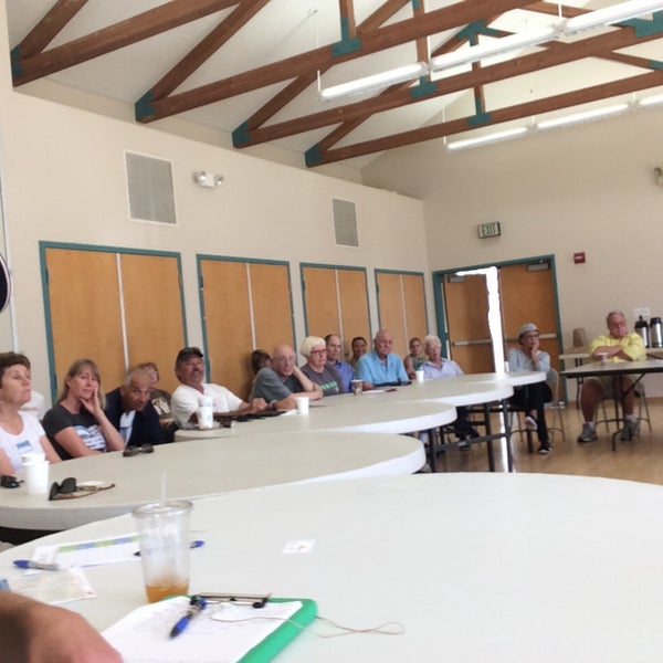 Diverse attendees in a semi-circle meeting at Alta Vista Community Center, fostering discussion.