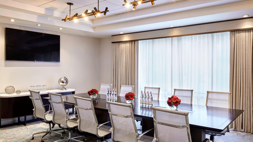 Modern conference room with wooden table at Courtyard Los Angeles Burbank Airport meetings.