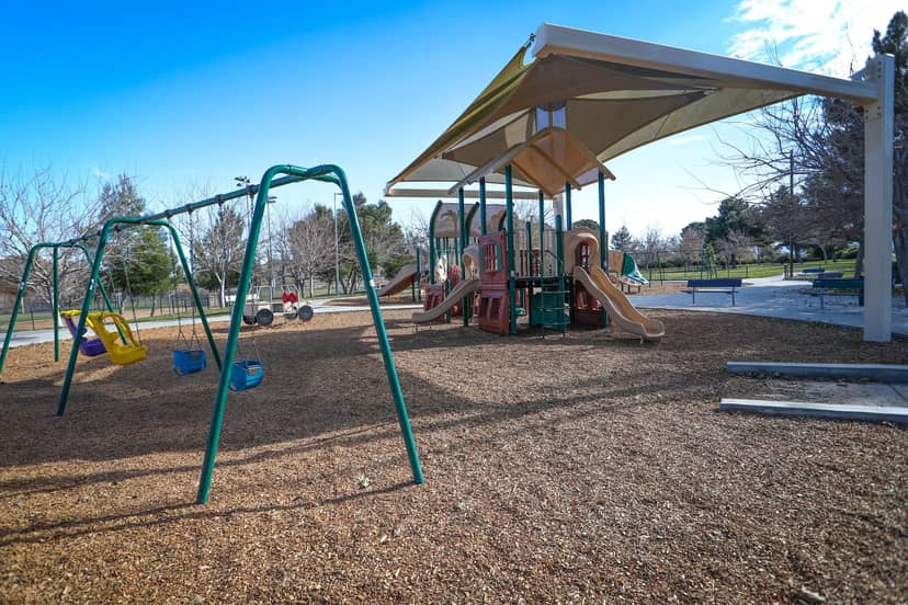Playground at Lake Street Community Center with shaded play structure for family events.