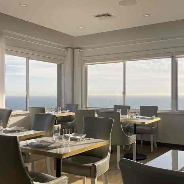 Penthouse dining space with ocean views, perfect for upscale events and meetings.