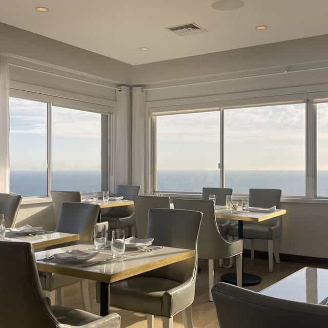 Penthouse dining space with ocean views, perfect for upscale events and meetings.