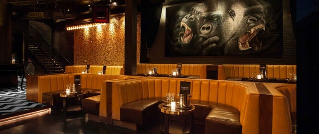 Stylish venue with plush seating and gorilla mural, ideal for networking events.