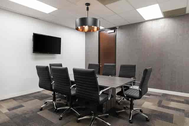 Modern Executive Boardroom with large table, ideal for meetings and presentations.
