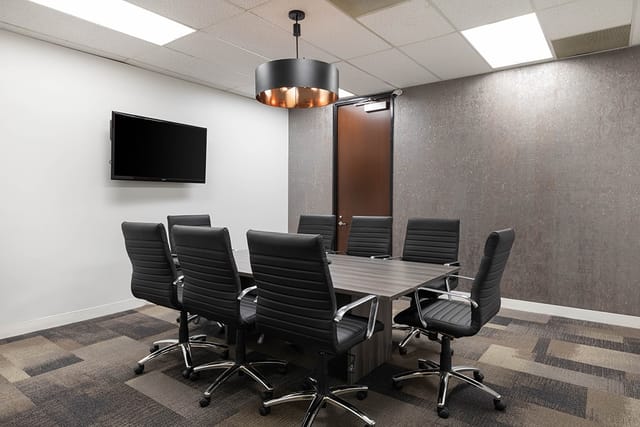 Modern Executive Boardroom with large table, ideal for meetings and presentations.