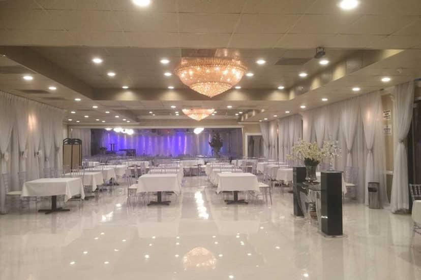 Elegant banquet hall with white table settings, perfect for events and gatherings.