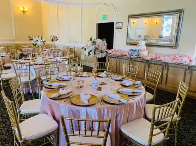 Elegant banquet room with pink linens, ideal for weddings and formal events.