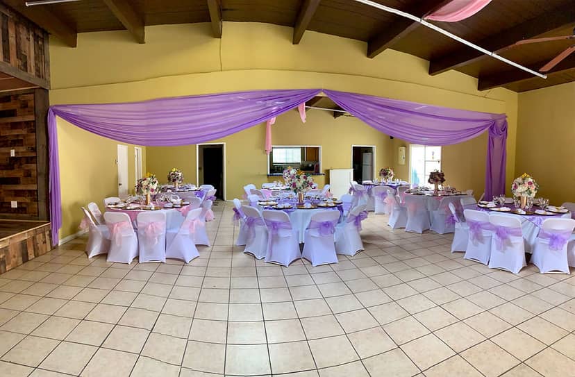 Elegant event space with purple drapery, ideal for weddings and parties.