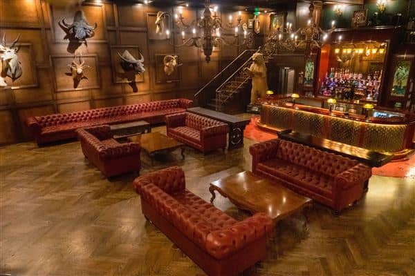 Sophisticated Trophy Room lounge with leather seating for networking events.