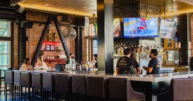 Vibrant bar in Suite #101 at Social Tap Eatery for casual networking events.