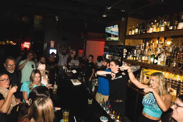 DJ Krispy performing at Club Marina, vibrant bar scene for networking events and social gatherings.