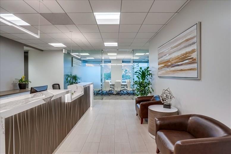 Modern reception area with glass-walled meeting room, ideal for professional events.