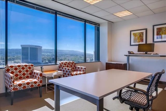 Modern meeting space with large windows, ideal for creative collaboration and presentations.
