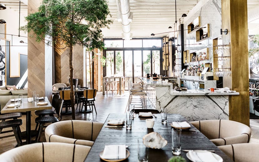 Modern restaurant bar in Norah, featuring elegant furnishings for events and gatherings.