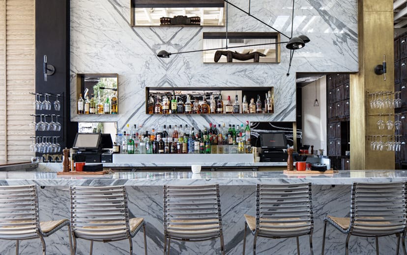 Sleek marble bar in Norah, ideal for networking events and cocktail receptions.