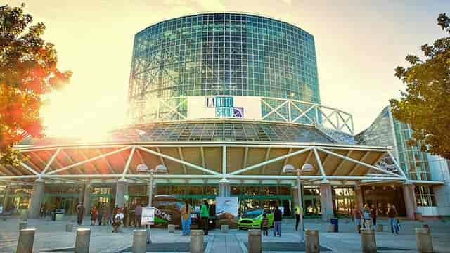 Vibrant convention center with glass facade, ideal for auto show events.