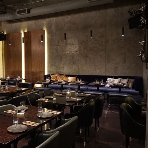 Modern dining room with dark wood tables, perfect for intimate gatherings and corporate dinners.