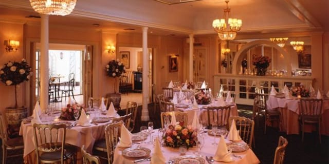 Elegant dining room with floral centerpieces, perfect for weddings and formal events.