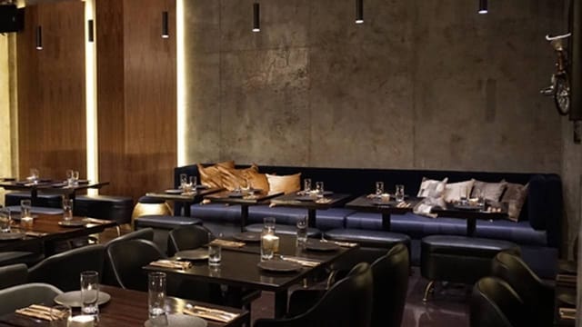 Modern dining area with warm lighting, ideal for intimate gatherings and corporate events.