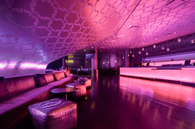 Sleek modern venue with purple ambiance, ideal for upscale cocktail receptions.