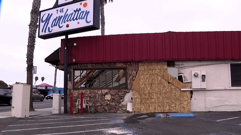 Manhattan bar with boarded-up windows, raising safety concerns for events.