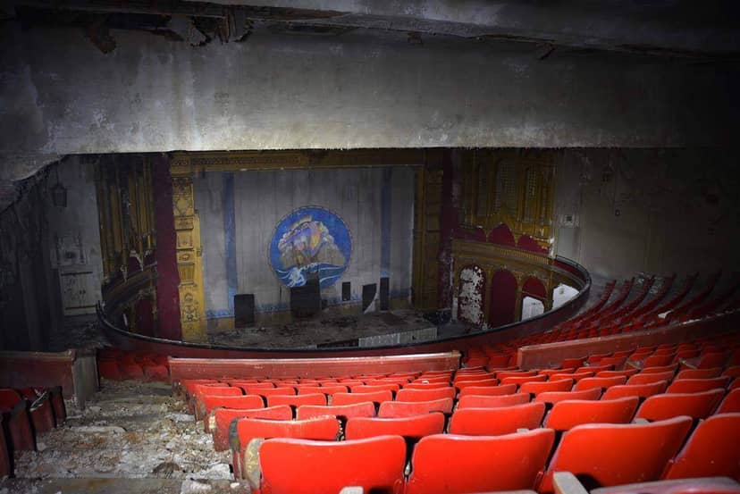 Liberty Hall Theatre's worn red seats highlight vintage venue challenges for events.