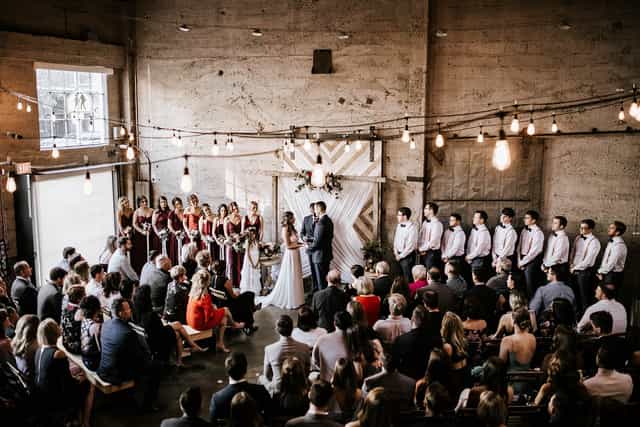 Groom and Bridal Suites at Luce Loft, elegant wedding ceremony with warm lighting.